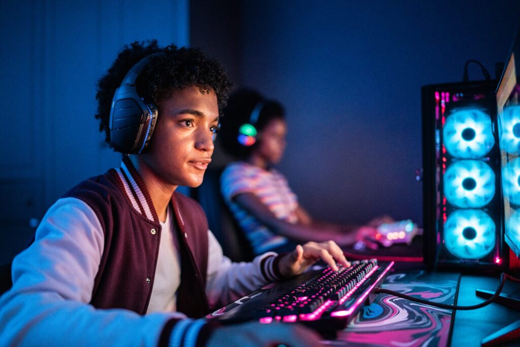 Teens playing video games with headphones on