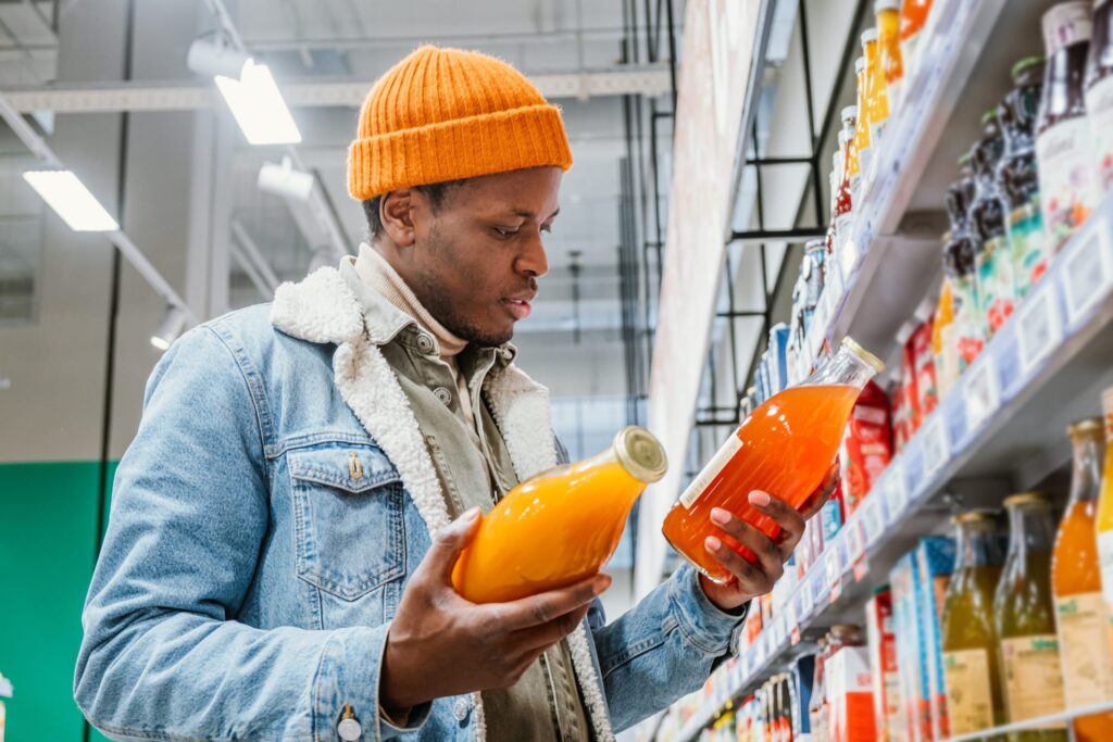 Man comparing two products in store