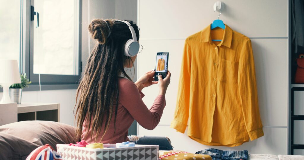 Woman taking photo to sell clothes online